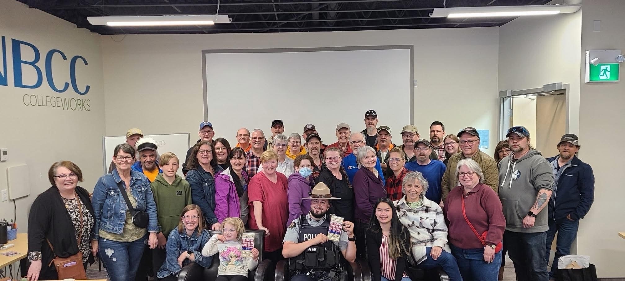 Large group of community members and an RCMP officer at an NBCC CollegeWorks event